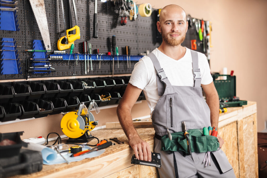 smiling foreman in work clothes holding stapler in 2021 08 26 18 52 37 utc